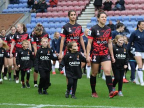 Captain Gabrielle Hindley leads the Canada Ravens out during a Saturday, Nov. 5, 2022 match in Wigan, England against England at the Rugby League World Cup in this handout photo. The Canadian women wrap up tournament play Wednesday against Brazil at Headingley Stadium in Leeds.