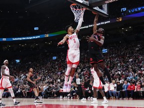 Toronto Raptors forward Precious Achiuwa (5) jumps up against Houston Rockets forward Kenyon Martin Jr. (6) during first half NBA basketball action in Toronto on Wednesday, Nov. 9, 2022. Achiuwa has been diagnosed with partial ligament tears in his right ankle, and is listed as out indefinitely.