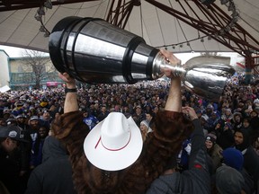 Winnipeggers are crowd the downtown streets Tuesday, Nov. 26, 2019, to celebrate with quarterback Chris Streveler as he raises the cup with other players following their Grey Cup win in Calgary. Canadian artist Josh Ross is set to perform alongside Jordan Davis and Tyler Hubbard of Florida Georgia Line at the Grey Cup.
