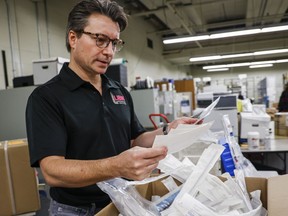 Dr. Paul Fedak sorts through medical and surgical supplies destined for Ukraine at the Foothills Medical Centre in Calgary, Alta., Thursday, Nov. 17, 2022.