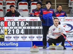 Canada skip Brad Gushue, left, directs his teammates as Korea skip Jeong Byeongjin looks on during the men's gold medal game against Korea at the Pan Continental Curling Championships in Calgary on November 6, 2022.