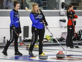 Skip Jennifer Jones, right, and vice skip Mackenzie Zacharias discuss strategy as they compete at the Autumn Gold bonspiel in Calgary, Alta., Sunday, Oct. 30, 2022.THE CANADIAN PRESS/Jeff McIntosh