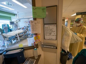 Nurse Manjot Kaur Munday prepares with her PPE before attending to a COVID-19 patient at Surrey Memorial Hospital in Surrey, B.C. The Trudeau government has promised $45.2 billion in Canada Health Transfers to the provinces this year. File photo