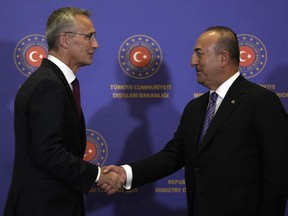 NATO Secretary General Jens Stoltenberg left, shakes hands with Turkish Foreign Minister Mevlut Cavusoglu following a press conferences in Istanbul, Thursday, Nov. 3, 2022.