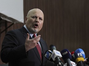 FILE - Karim Ahmed Khan, International Criminal Court chief prosecutor, speaks during a news conference at the Ministry of Justice in the Khartoum, Sudan, on Aug. 12, 2021. Khan sought Tuesday, Nov. 1, 2022 to reopen his investigation into allegations of torture and extrajudicial killings committed by security forces under President Nicolas Maduro's rule.