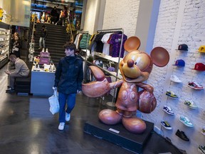 A statue of Mickey Mouse with lobster claws is displayed at the Concepts shoe store on Newbury Street in Boston on Tuesday, Nov. 22, 2022. Made back in 2004 for Disney's 75th anniversary, it was a sensation when it first debuted on public display downtown.
