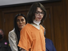 FILE - Ethan Crumbley answers "yes" to charges against him from assistant prosecutor during his pre-trial hearing at Oakland County Courthouse, Oct. 24, 2022, in Pontiac, Mich. On Monday, Nov. 14, prosecutors said they will seek a life sentence with no chance for parole for the 16-year-old boy who killed four fellow students at a Michigan school and pleaded guilty to murder and terrorism.