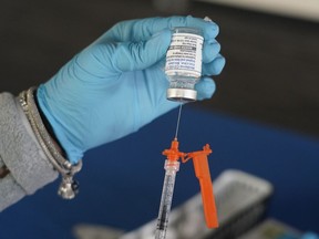 A Jackson-Hinds Comprehensive Health Center nurse loads a syringe with a Moderna COVID-19 booster vaccine at an inoculation station next to Jackson State University in Jackson, Miss., Friday, Nov. 18, 2022. Moderna recently announced early evidence that its updated booster induced BQ.1.1-neutralizing antibodies.