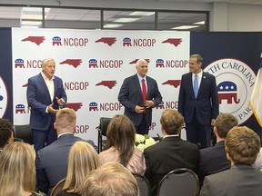 Former Vice President Mike Pence, center, joins with North Carolina Republican Party Chairman Michael Whatley, left, and U.S. Senate candidate Ted Budd for a conservation at the state GOP headquarters in Raleigh, N.C., on Wednesday. Nov. 2, 2022. Pence was in North Carolina to support Budd's campaign.