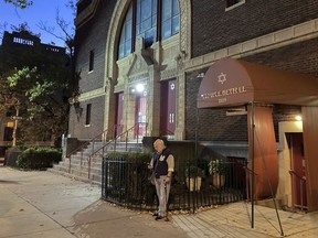 A man stands outside Temple Beth El synagogue, Thursday, Nov. 3, 2022, in Jersey City, N.J. The FBI says it has received credible information about a threat to synagogues in New Jersey. The FBI's Newark office released a statement Thursday afternoon that characterizes it as a broad threat. The statement urged synagogues to "take all security precautions to protect your community and facility."