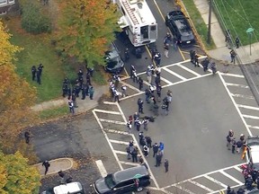 In this image provided by WABC-TV, police respond to a report of officers shot Tuesday, Nov. 1, 2022, in Newark, N.J. Details on the number of officers injured or the extent of their injuries weren't immediately available. (WABC-TV via AP)