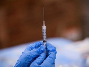A syringe is filled with a dose of Pfizer's COVID-19 vaccine at a pop-up community vaccination centre at the Gateway World Christian Center in Valley Stream, New York.