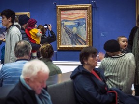 FILE - People look at Edvard Munch's "The Scream" at the National Gallery in Oslo, Norway, Sunday Jan. 13, 2019. On Friday, Nov. 11, 2022, activists from the organization ''Stopp oljeletinga'' (Stop Oil Exploration) tried to glue themselves to the frame of the painting.