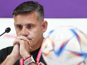 Canada head coach John Herdman looks down unhappily after being well over 30 minutes late for their opening press conference ahead of their first match against Belgium at the World Cup in Doha, Qatar during on Tuesday, November 22, 2022.