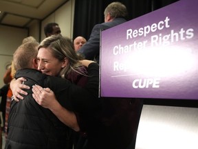 CUPE-OSBCU president Laura Walton hugs a supporter following a press conference in Toronto on Monday Nov. 7, 2022.&ampnbsp;Ontario schools are reopen again for in-person learning today after many were shut since Friday due to a walkout by education workers. The Canadian Union of Public Employees says its 55,000 education workers will be back on the job today after Premier Doug Ford agreed to rescind a law that imposed contracts on them.