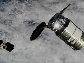 This photo provided by NASA shows a Northrop Grumman cargo ship about to be captured by the International Space Station's robot arm on Wednesday, Nov. 9, 2022. The capsule delivered more than 8,000 pounds of supplies to the International Space Station on Wednesday, despite a jammed solar panel.  (NASA via AP)