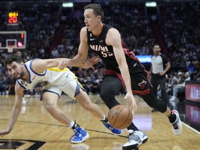 FILE - Miami Heat forward Duncan Robinson (55) drives to the basket past Golden State Warriors guard Ty Jerome (10) during the second half of an NBA basketball game at FTX Arena, Nov. 1, 2022, in Miami. The Heat and Miami-Dade County decided Friday, Nov. 11, 2022, to terminate their relationship with FTX on the same day the cryptocurrency exchange filed for bankruptcy. The building had been called FTX Arena since June 2021, and a 19-year, $135 million sponsorship agreement between FTX and the county was just getting started.