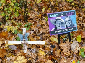 FILE - A makeshift memorial to Liberty German and Abigail Williams near where they were last seen and where the bodies were discovered stands along the Monon Trail leading to the Monon High Bridge Trail in Delphi, Ind., Oct. 31, 2022. An Indiana judge could rule Tuesday, Nov. 22, 2022, if sealed court documents with evidence that led to a man's arrest in the 2017 slayings of the two teenage girls will be publicly released.