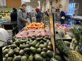Shoppers pick out items at a grocery store in Glenview, Ill., Saturday, Nov. 19, 2022. On Wednesday the Commerce Department issues its second of three estimates of how the U.S. economy performed in the second quarter of 2022.