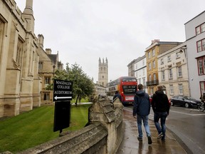 FILE - People walk around Oxford University's campus in Oxford, England on Sept. 3, 2017. A new group of Rhodes Scholars from the U.S. has been selected for the prestigious academic program in a selection process that was conducted online for the third consecutive year, the Office of the American Secretary of the Rhodes Trust said in a statement early Sunday, Nov. 13, 2022.