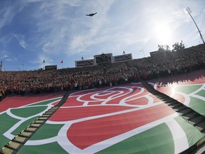 The Rose Bowl logo is seen during a fly over before the Rose Bowl NCAA college football game between Utah and Ohio State Saturday, Jan. 1, 2022, in Pasadena, Calif. Flipping the current college football playoff from four-teams to a 12-teams for the final two years of the current television contract will give those in charge of the postseason a look at how it works before committing to anything long term. But, The Granddaddy of Them All wants the CFP management committee to assure game organizers that their game will continue to be played annually on New Year's Day.