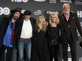 FILE - Members of Fleetwood Mac, from left, Mike Campbell, John McVie, Stevie Nicks, Christine McVie and Mick Fleetwood appear at the Rock & Roll Hall of Fame induction ceremony in New York on March 29, 2019. Christine McVie, the soulful British musician who sang lead on many of Fleetwood Mac's biggest hits, has died at 79. The band announced her death on social media Wednesday.