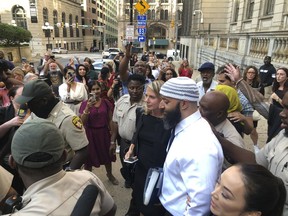 FILE - Adnan Syed, center, leaves the Cummings Courthouse, Monday, Sept. 19, 2022, in Baltimore. An appeal of the court proceedings that freed Adnan Syed from prison filed by the family of the murder victim in the case chronicled in the true-crime podcast "Serial" can move forward. Maryland's intermediate appellate court made the ruling Friday, Nov. 4, 2022