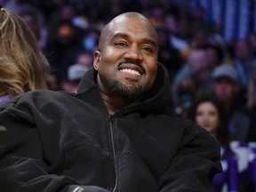 FILE - Kanye West watches the first half of an NBA basketball game between the Washington Wizards and the Los Angeles Lakers in Los Angeles, on March 11, 2022 Adidas says it is investigating allegations of inappropriate workplace conduct by the rapper formerly known as Kanye West that ex-employees made in an anonymous letter also accusing the German sportswear brand of looking the other way.
