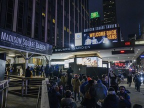 FILE - Fans line up outside Madison Square Garden for an NBA basketball game between the New York Knicks and the Golden State Warriors in New York, Tuesday, Feb. 23, 2021. On Monday, Nov. 14, 2022, a judge granted a partial victory to a lawyer who sued Madison Square Garden after he and his colleagues were barred from the Garden and other MSG-owned venues because their firm represents a group suing the company.