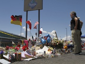 FILE - Mourners visit a makeshift memorial on Aug. 12, 2019, near the Walmart in El Paso, Texas, where people were killed in a mass shooting. On Monday, Nov. 28, 2022, a Texas prosecutor, facing mounting criticism over the handling of the 2019 Walmart mass shooting in El Paso, resigned after the county took the extraordinary step of moving to remove her from elected office.