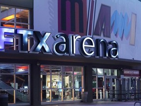 FILE - A sign for the FTX Arena, where the Miami Heat basketball team plays, is illuminated on Nov. 12, 2022, in Miami. FTX filed for bankruptcy protection Friday, Nov. 11.