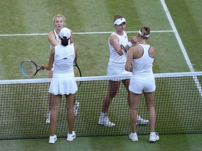 FILE - Barbora Krejcikova, top right, and Katerina Siniakova of the Czech Republic, celebrate after beating China's Shuai Zhang, bottom left, and Belgium's Elise Mertens during the final of the women's doubles at the Wimbledon tennis championships in London, on July 10, 2022. Wimbledon is relaxing its requirement for all-white clothing to allow female players to wear colored undershorts to be more comfortable on their periods.