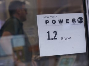 A sign on a convenience store advertises the Powerball lottery in New York, Tuesday, Nov. 1, 2022. The jackpot climbed to $1.2 billion after no one matched all six numbers to win the jackpot.