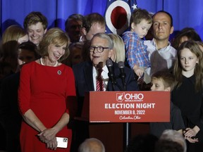 Republican Ohio Gov. Mike DeWine, right, speaks during an election night watch party as his wife, Fran, and their family stand on stage Tuesday, Nov. 8, 2022, in Columbus, Ohio.
