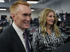 U.S. Sen. James Lankford, left, and his wife Cindy Lankford, right, greet supporters at a Republican Party watch party Tuesday, Nov. 8, 2022, in Oklahoma City.