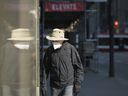 A pedestrian wears a mask as they walk through a quiet downtown area in Toronto on Wednesday, April 7, 2021.  Two government sources say Ontario's top doctor will recommend the public start wearing masks Monday in an effort to help overwhelmed children's hospitals.  THE CANADIAN PRESS/ Tijana Martin