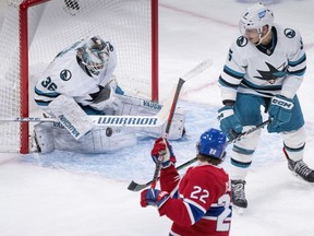San Jose Sharks goaltender Kaapo Kahkonen makes a save off Montreal Canadiens' Cole Caufield as defenceman Matt Benning looks on during first period NHL hockey action in Montreal, on Tuesday, November 29, 2022.