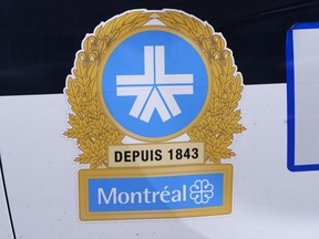 The Montreal Police logo is seen on a police car in Montreal on Wednesday, July 8, 2020. A Montreal anti-racism group says city police should apologize to a Black man who handcuffed Thursday after officers suspected he was attempting to steal his own car.