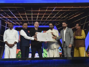 This photograph released by Indian government's Press Information Bureau shows Israel filmmaker and jury chairperson Nadav Lapid, third left, being honored by Indian ministers at the closing ceremony of the International Film Festival of India in Goa, India, Monday, Nov.28, 2022. Israel's envoy to India Tuesday denounced Lapid after he called a controversial Bollywood film on disputed Kashmir a "propaganda" and "vulgar movie" at the film festival, stoking a flurry of debate on social media. ( Press Information Bureau via AP)