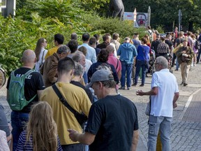 FILE --People queue in front of a polling station in the Moabit district of Berlin, Germany, Sunday, Sept. 26, 2021. A Berlin court on Wednesday ordered a rerun of the German capital's 2021 state election because of severe election-day glitches at many polling stations.