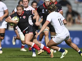 Justine Pelletier of Canada runs with the ball during the women's rugby World Cup semifinal between Canada and England at Eden Park in Auckland, New Zealand, Saturday, Nov. 5, 2022. Canada coach Kevin Rouet gets to hear both his national anthems Friday when third-ranked Canadian women takes on No. 4 France in the Rugby World Cup bronze-medal game in Auckland.