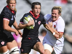 Elissa Alarie of Canada runs at the defence during the women's rugby World Cup semifinal between Canada and England at Eden Park in Auckland, New Zealand, Saturday, Nov. 5, 2022. Canada has turned heads with its performance at the Rugby World Cup. Now the third-ranked Canada women look to turn that respect into a bronze medal when they take on No. 4 France for third place. Both teams are looking to bounce back from the disappointment of losing close semifinals last weekend.