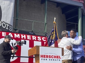 Georgia Gov. Brian Kemp campaigns alongside Senate candidate Herschel Walker on Saturday, Nov. 19, 2022 in Smyrna, Ga.