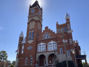 The sun spotlights the tower of the historic Terrell County courthouse on Friday, Oct. 7, 2022 in Dawson, Ga. Candidates, parties and outside groups are increasing their emphasis on door-to-door outreach as Georgia grows more politically competitive.