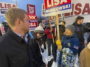 U.S. Sen. Lisa Murkowski, a Republican seeking reelection in Alaska, is shown talking with her nephew, Luke Murkowski, who flew in from Nome, Alaska, to surprise her at a sign-waving event on a busy Anchorage, Alaska, corner on Election Day, Tuesday, Nov. 8, 2022.