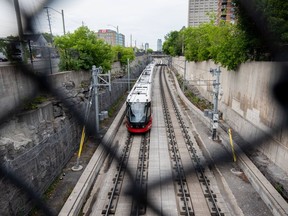 An Ottawa Light Rail Transit (LRT) train drives along the tracks in Ottawa, Ont. on Sunday, July 24, 2022.