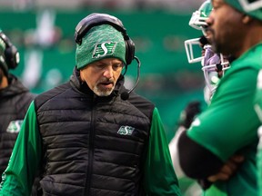 Saskatchewan Roughriders head coach Craig Dickenson looks downwards during the first half of CFL football action against the Calgary Stampeders in Regina on Oct. 22, 2022. Dickenson will return to helm the Roughriders for a fifth straight season, but several members of his coaching staff are paying the price after the team spiralled out of the playoffs following a season-ending seven-game losing streak.