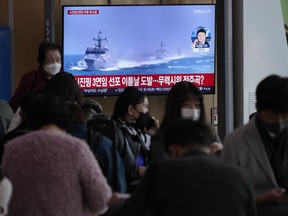 A TV screen shows a file image of South Korean navy vessels during a news program at the Seoul Railway Station in Seoul, South Korea, Monday, Oct. 24, 2022. The rival Koreas exchanged warning shots along their disputed western sea boundary on Monday, their militaries said, amid heightened animosities over North Korea's recent barrage of weapons tests.