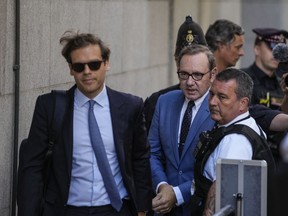 FILE - Actor Kevin Spacey, center, arrives at the Old Bailey, in London, Thursday, July 14, 2022. Actor Kevin Spacey will be charged with seven further sex offenses, all against one man, Britain's Crown Prosecution said Wednesday, Nov. 16, 2022.