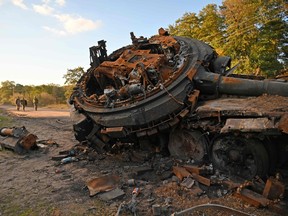 A destroyed Russian tank is seen on a road near Izyum, eastern Ukraine on October 7, 2022.